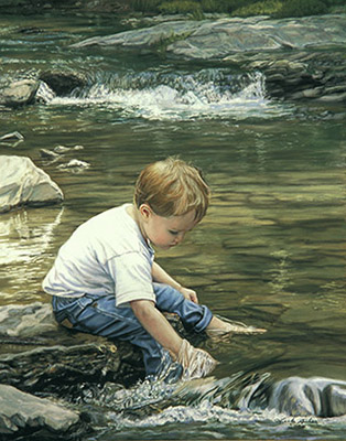 small boy playing in a stream